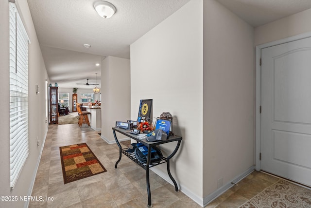 hallway with a textured ceiling