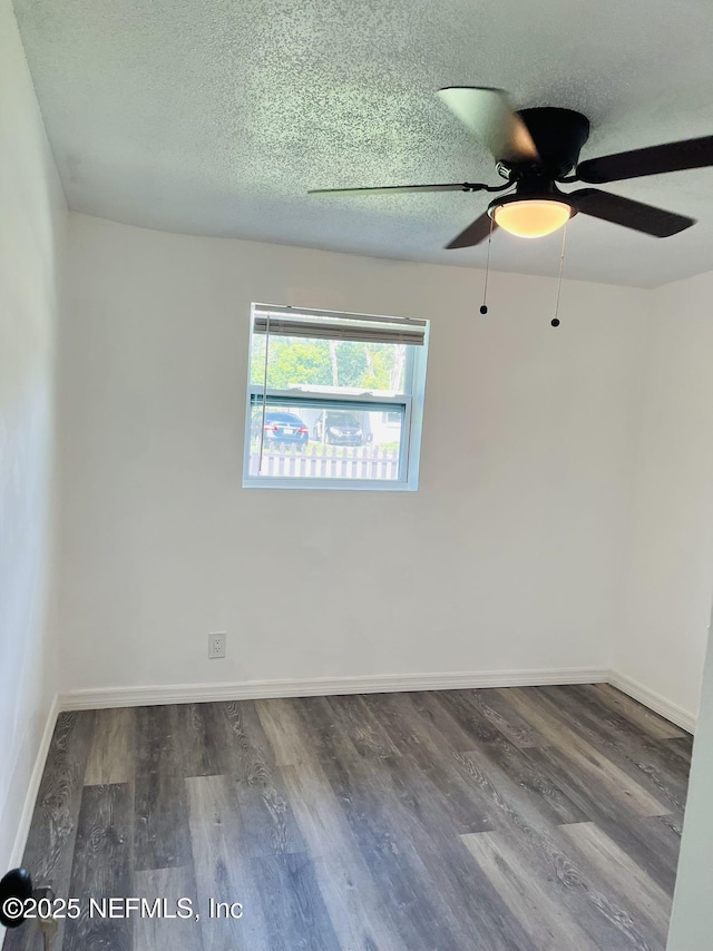 spare room with ceiling fan, wood-type flooring, and a textured ceiling