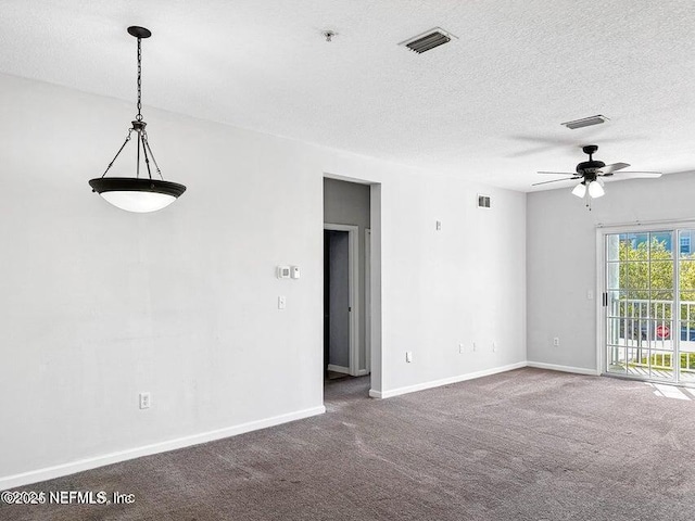 carpeted spare room with ceiling fan and a textured ceiling