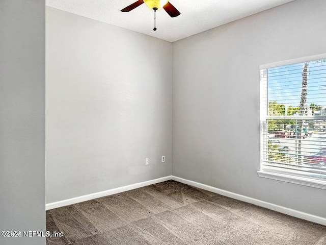 spare room with carpet and ceiling fan