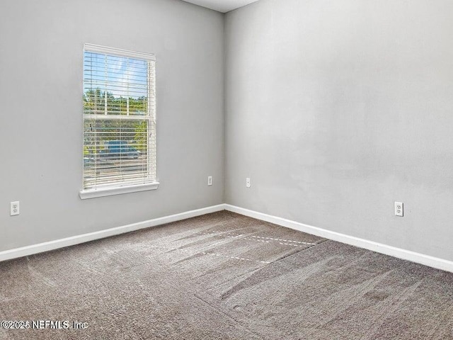 unfurnished room featuring carpet