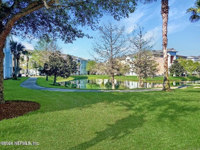 view of home's community featuring a water view and a yard