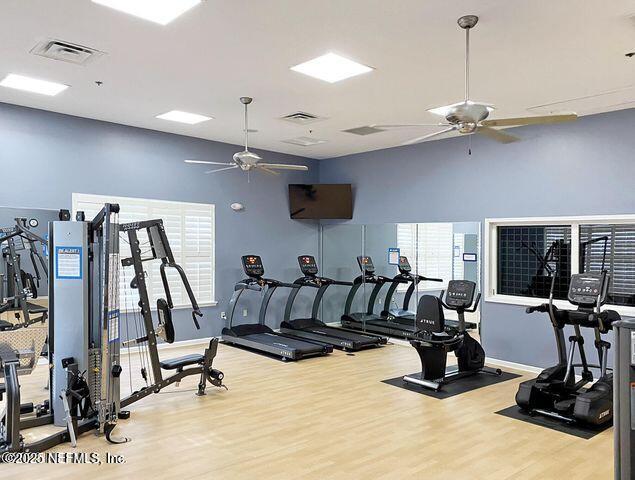 exercise room featuring wood-type flooring and ceiling fan