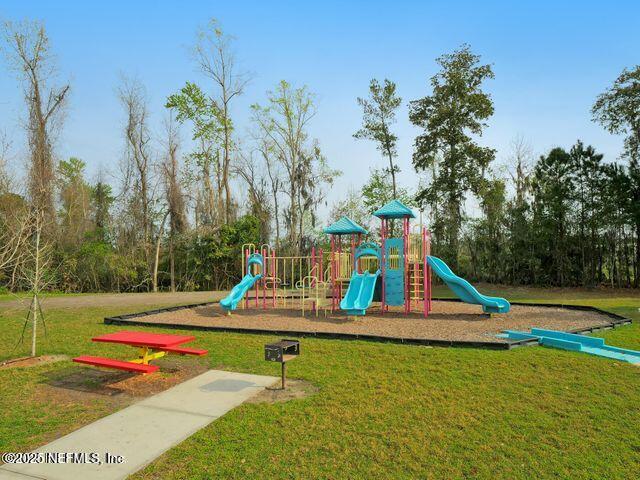 view of playground featuring a lawn