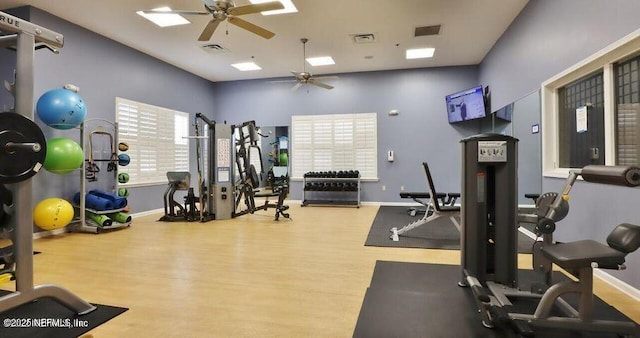 exercise room with hardwood / wood-style flooring and ceiling fan