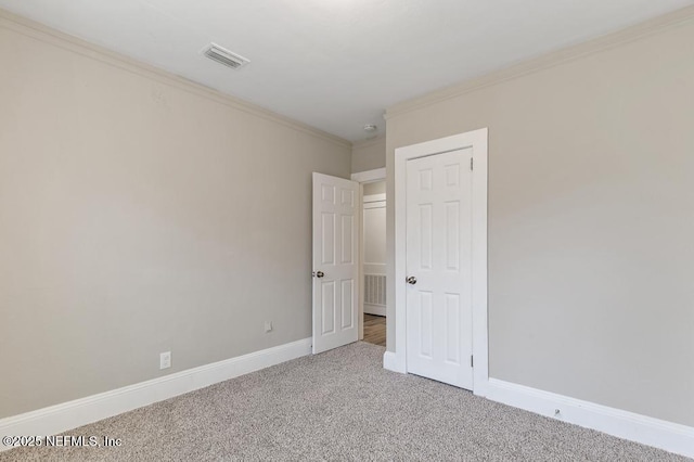 spare room with carpet floors and ornamental molding