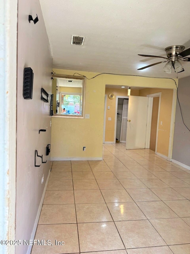 hall with light tile patterned floors