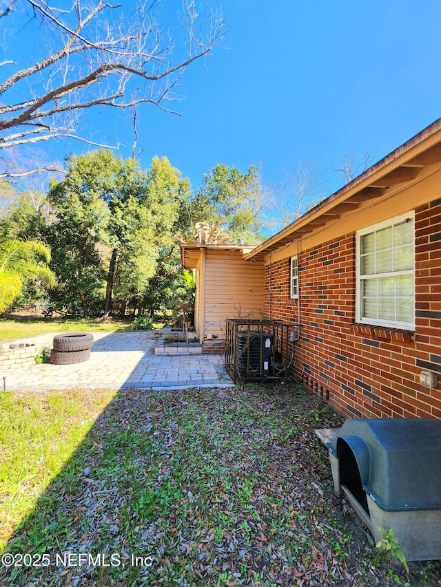 view of yard featuring a patio area and an outdoor fire pit