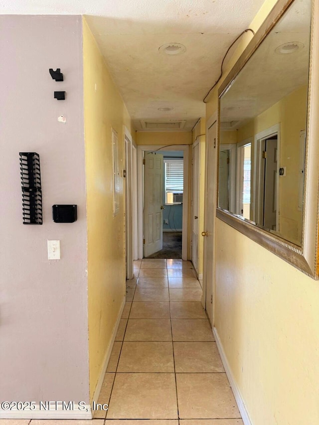 hallway featuring light tile patterned floors