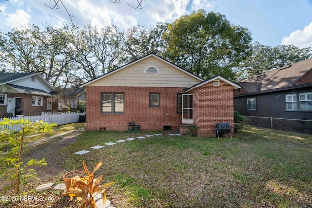 rear view of property with a yard