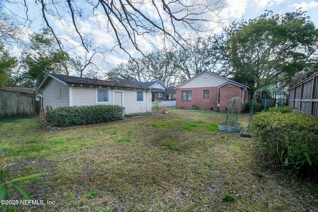 rear view of property with a lawn