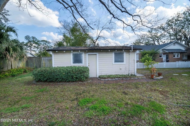 back of property featuring a lawn