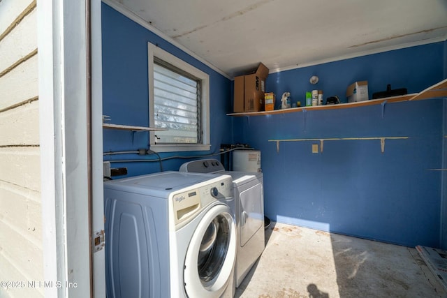 laundry area featuring washing machine and clothes dryer and water heater