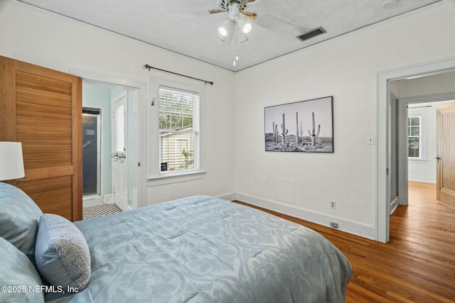 bedroom featuring hardwood / wood-style flooring, ceiling fan, and a textured ceiling