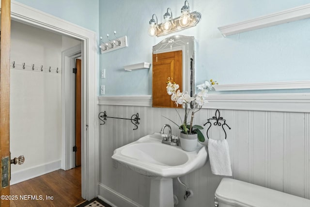 bathroom featuring hardwood / wood-style flooring and toilet