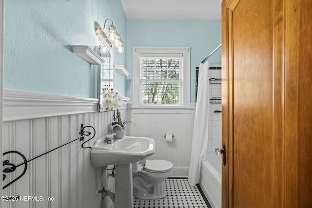 bathroom with tile patterned floors, toilet, and shower / bath combo