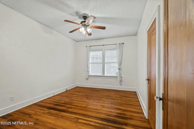 unfurnished room with dark hardwood / wood-style floors, a textured ceiling, and ceiling fan