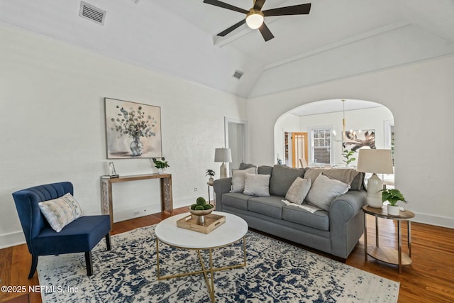 living room with lofted ceiling, hardwood / wood-style floors, and ceiling fan with notable chandelier