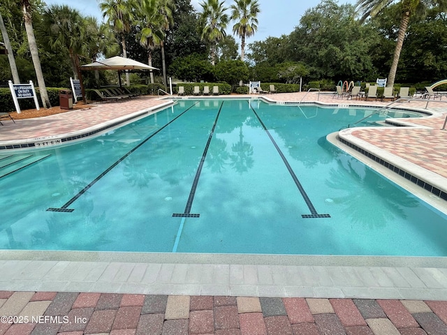 community pool with a patio area