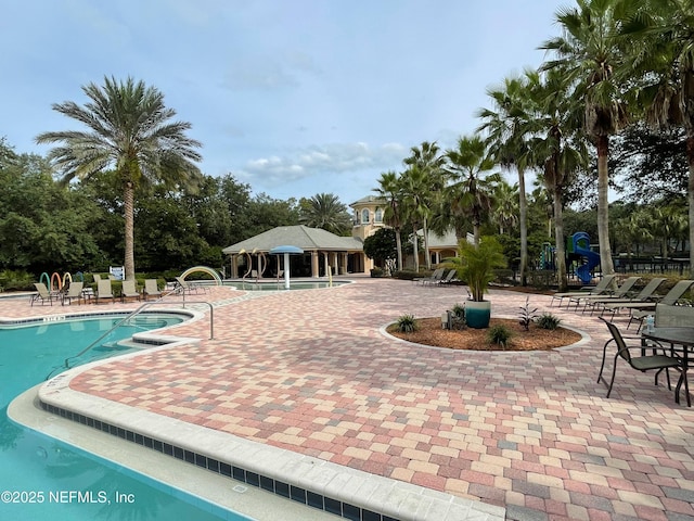 community pool with a patio area