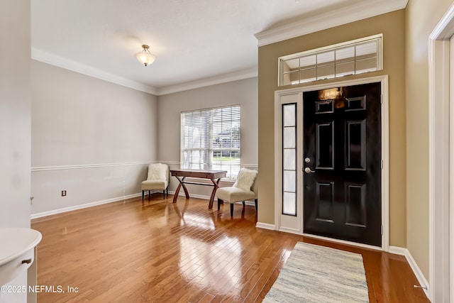 foyer featuring crown molding, baseboards, and wood-type flooring