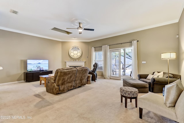 living area featuring light carpet, a fireplace, crown molding, and ceiling fan