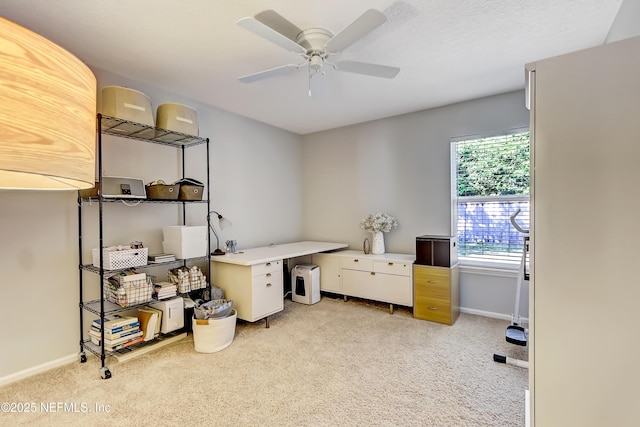 office with light colored carpet, baseboards, and a ceiling fan