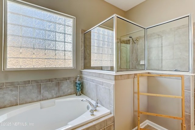 full bath with a bath and a tile shower