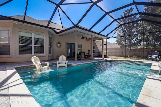 view of swimming pool featuring a patio, a ceiling fan, a fenced in pool, fence, and french doors