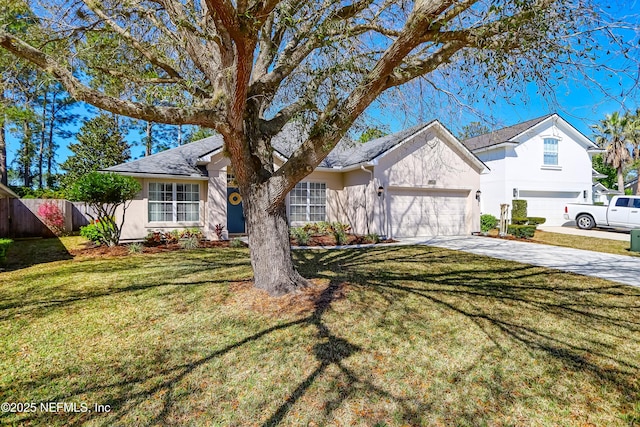 view of front of house featuring stucco siding, fence, concrete driveway, a front yard, and a garage