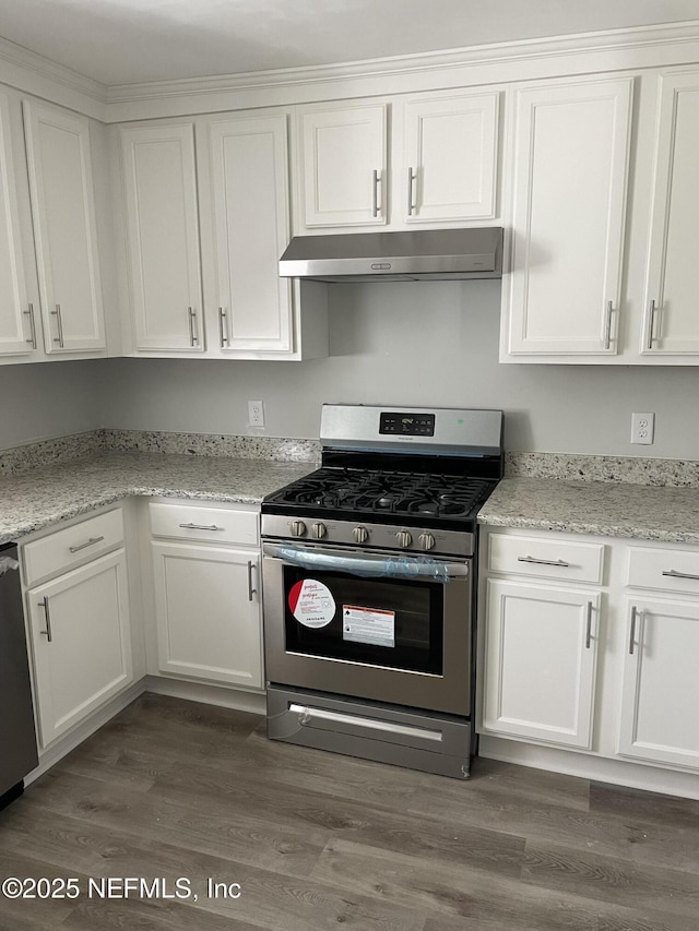 kitchen with light stone counters, stainless steel appliances, dark hardwood / wood-style floors, and white cabinets