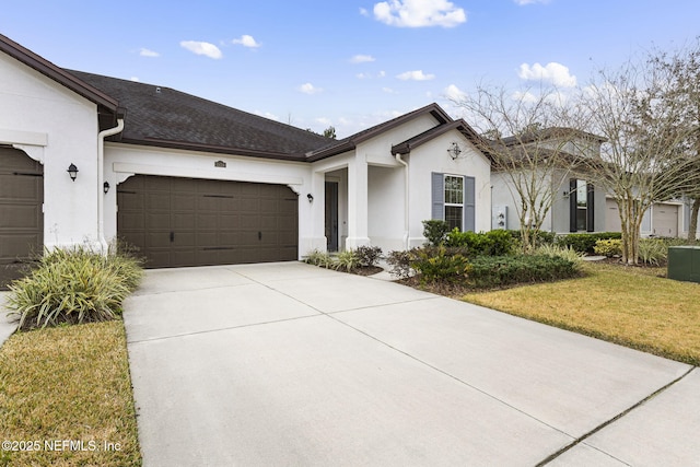 ranch-style house featuring a garage and a front lawn