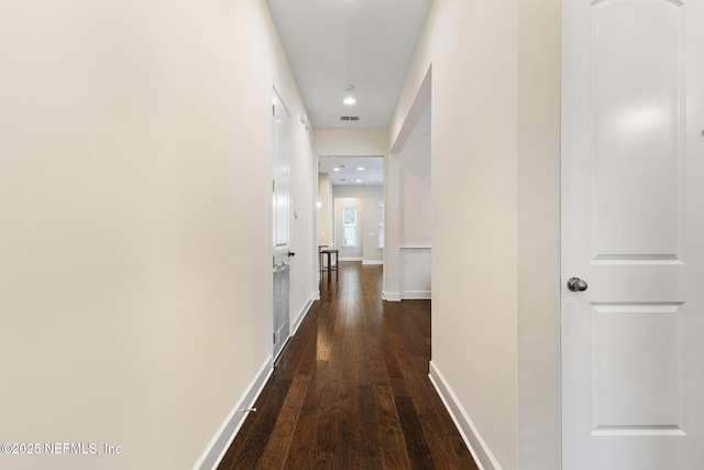 hallway with dark hardwood / wood-style floors