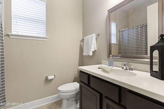 bathroom with tile patterned floors, vanity, toilet, and curtained shower