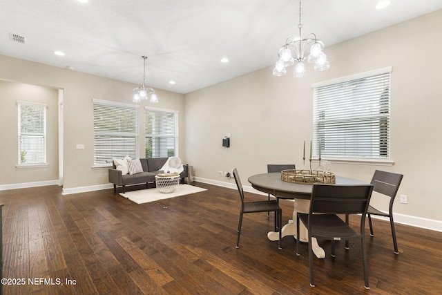 dining room featuring dark hardwood / wood-style flooring, a chandelier, and a wealth of natural light