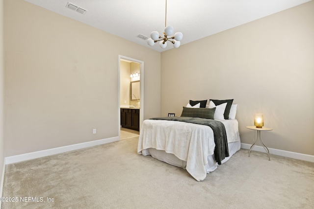 bedroom with light carpet, a notable chandelier, and ensuite bathroom