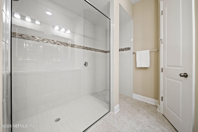 bathroom featuring tiled shower and tile patterned floors