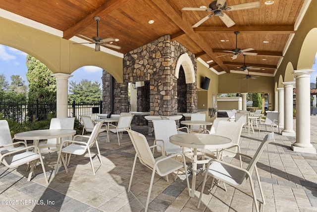 view of patio with ceiling fan and a fireplace