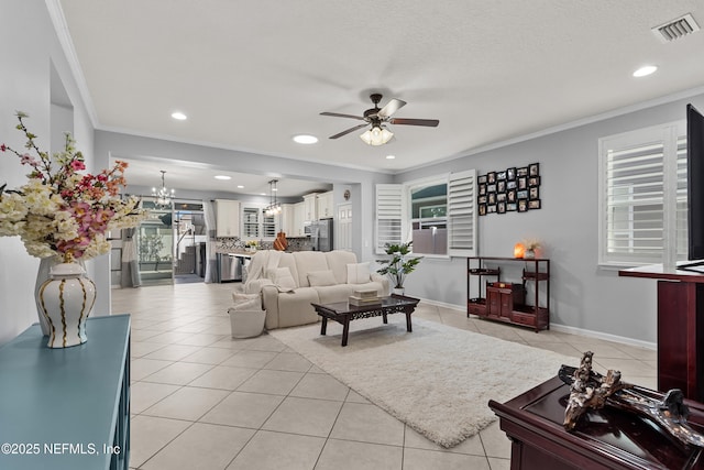 tiled living room featuring crown molding, ceiling fan with notable chandelier, and a textured ceiling