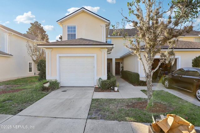 view of front of property with a garage and a front lawn