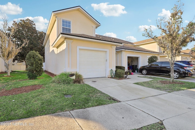 view of front facade featuring a garage and a front lawn