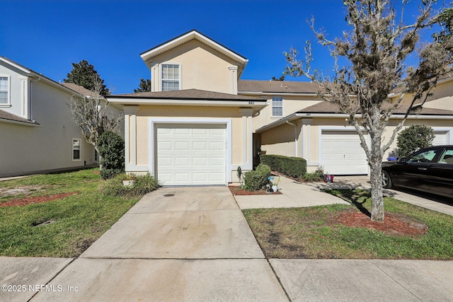 traditional-style home with a garage, driveway, a front lawn, and stucco siding