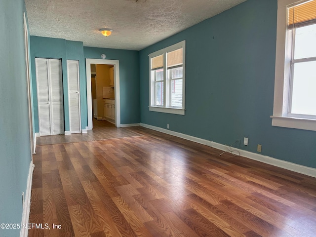 spare room with hardwood / wood-style floors and a textured ceiling