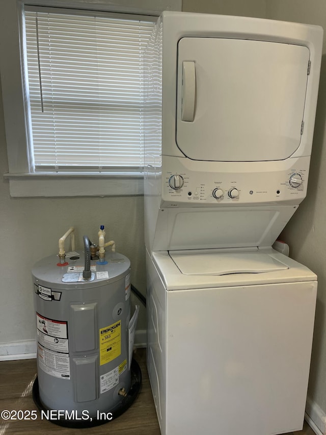 washroom with stacked washer and dryer, electric water heater, and dark hardwood / wood-style flooring