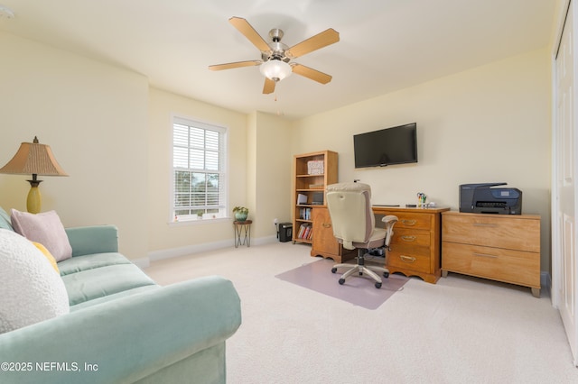 home office with ceiling fan and light carpet