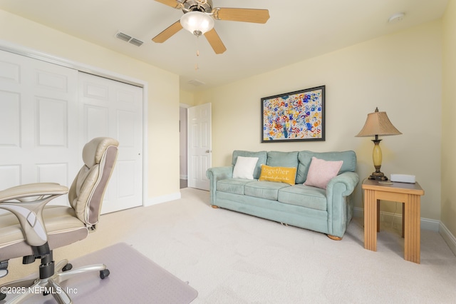 carpeted office space featuring ceiling fan