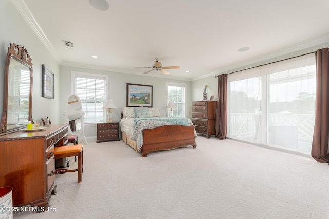 bedroom featuring multiple windows, crown molding, and access to exterior