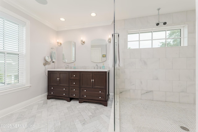 bathroom with ornamental molding, vanity, and a tile shower