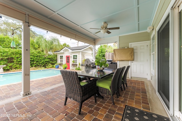 exterior space featuring a grill, an outbuilding, and ceiling fan