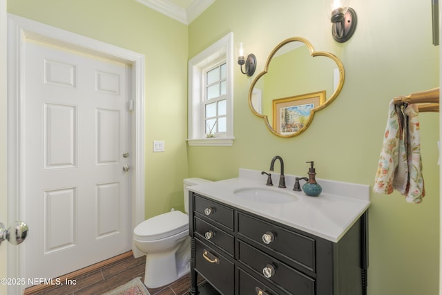 bathroom featuring ornamental molding, vanity, toilet, and wood-type flooring